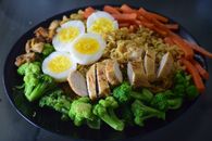 Cooked Meat With Sliced Eggs and Sliced Carrots on Black Ceramic Plate