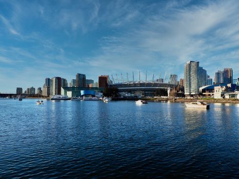 Panoramic view of Vancouver's skyline featuring BC Place and the scenic waterfront under a clear blue sky.