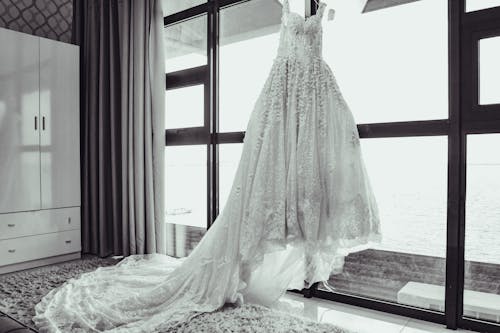 Free Grayscale Photo of White Wedding Dress on Window Stock Photo