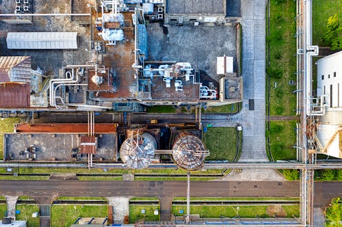 Free Aerial view of industrial complex consisting of tanks and pipes for producing petroleum products Stock Photo