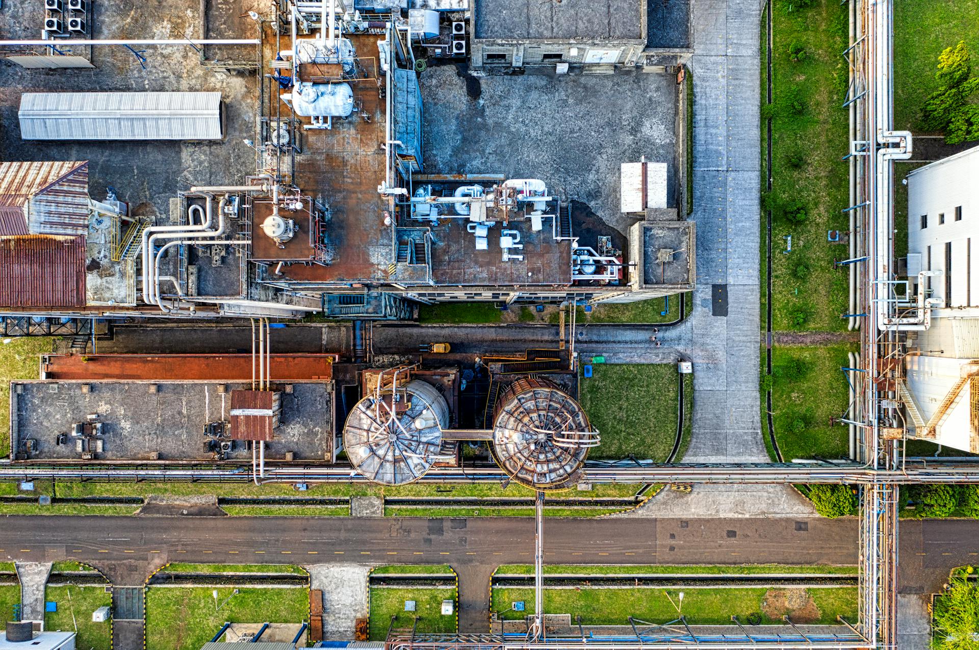 Aerial view of industrial complex consisting of tanks and pipes for producing petroleum products