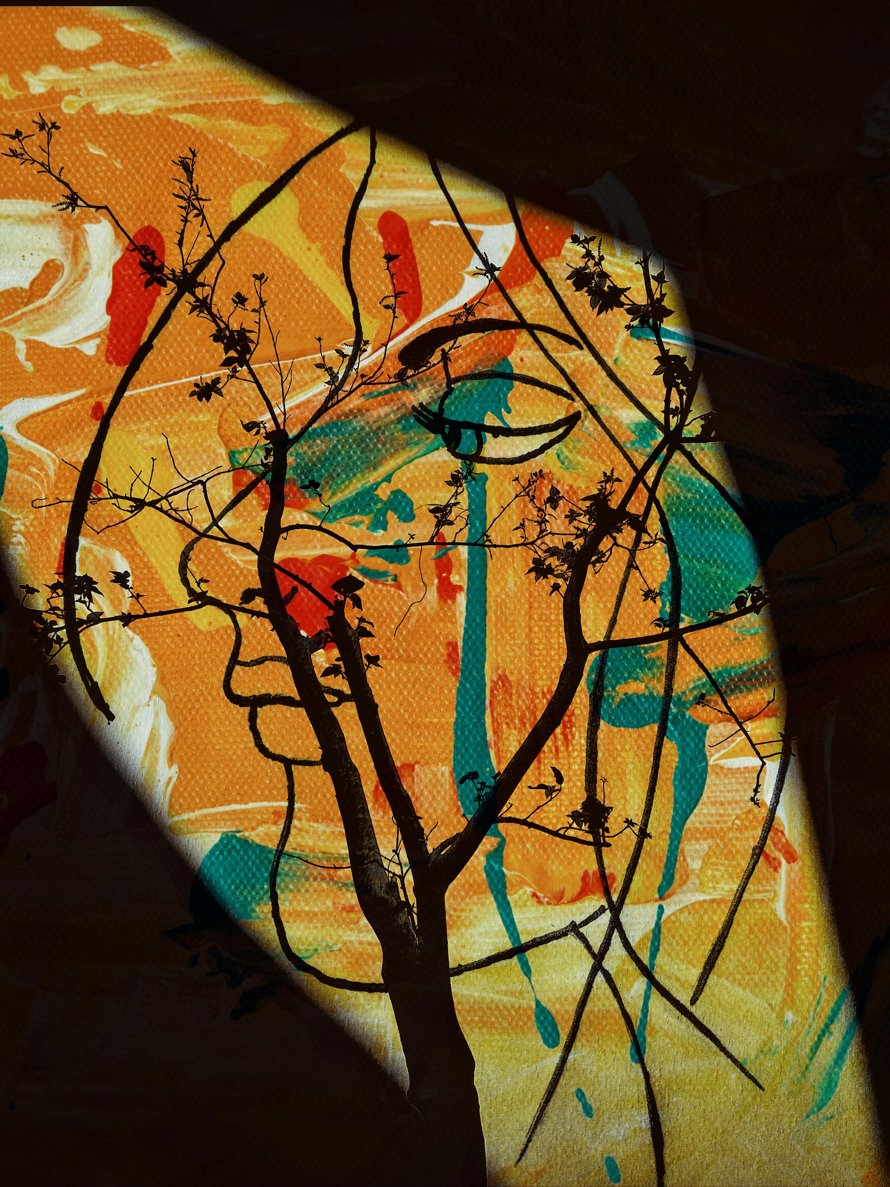 Artistic composition featuring a tree silhouette over an abstract colorful background.