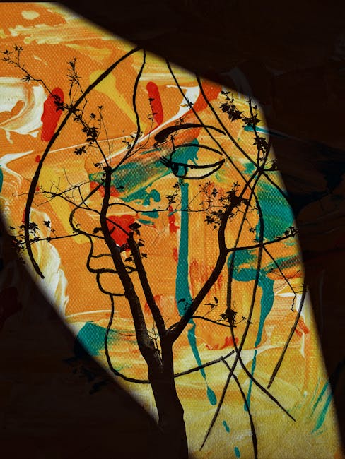 Artistic composition featuring a tree silhouette over an abstract colorful background.