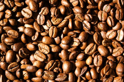 Free High-resolution close-up of roasted Arabica coffee beans showing intricate textures. Stock Photo