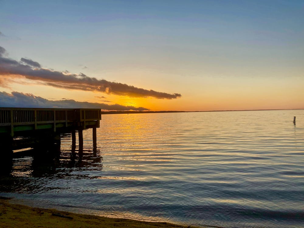 Brown Wooden Dock on Sea during Sunset