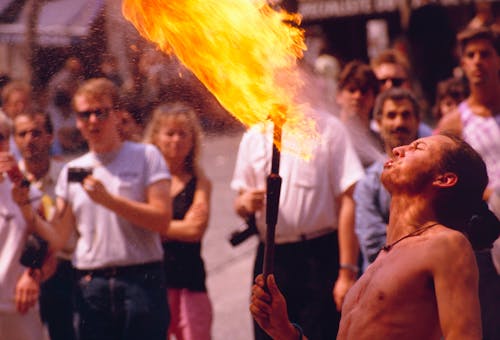 Shirtless Man Holding a Flame Torch