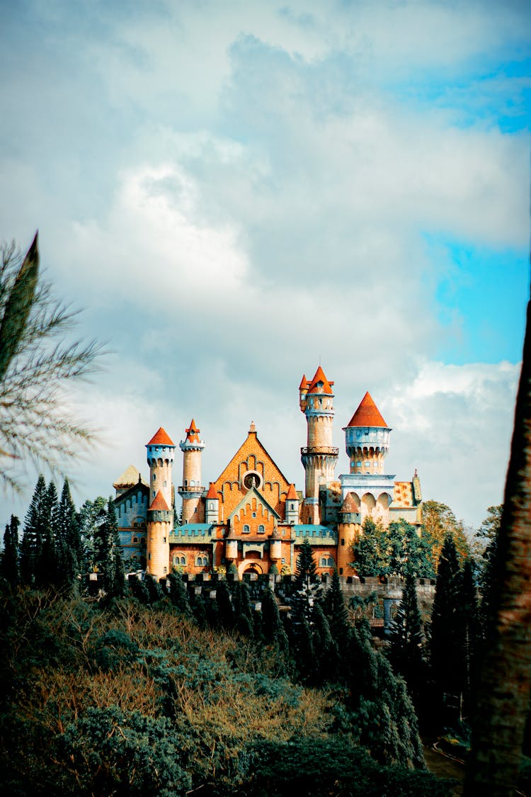 Colorful Castle Against Trees In Amusement Park