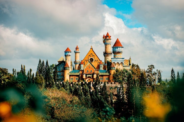 Castle Facade In Theme Park Under Cloudy Sky