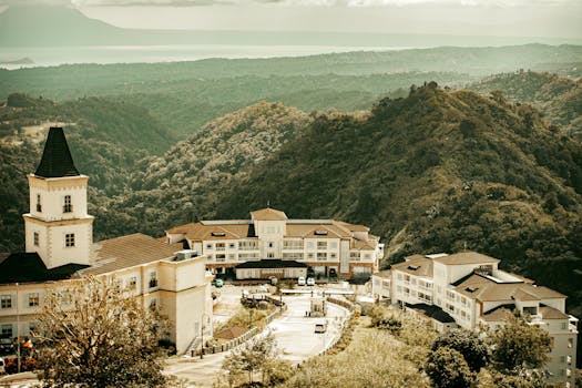 A picturesque resort nestled in lush green mountains offering a majestic view of nature.