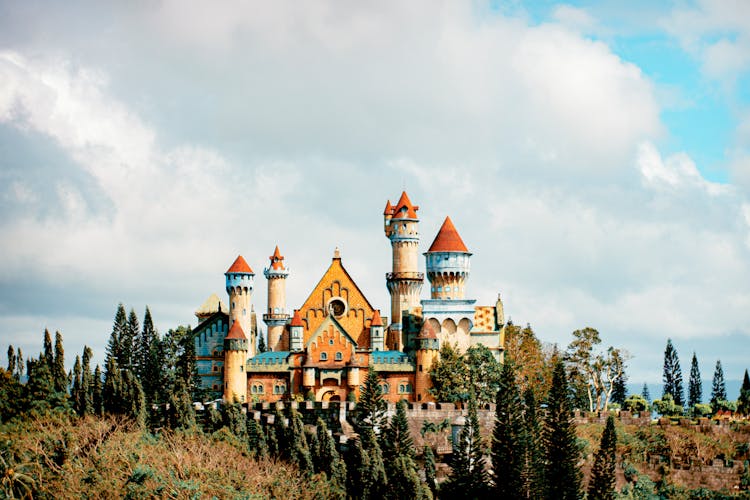 Castle In Amusement Park Under Cloudy Sky