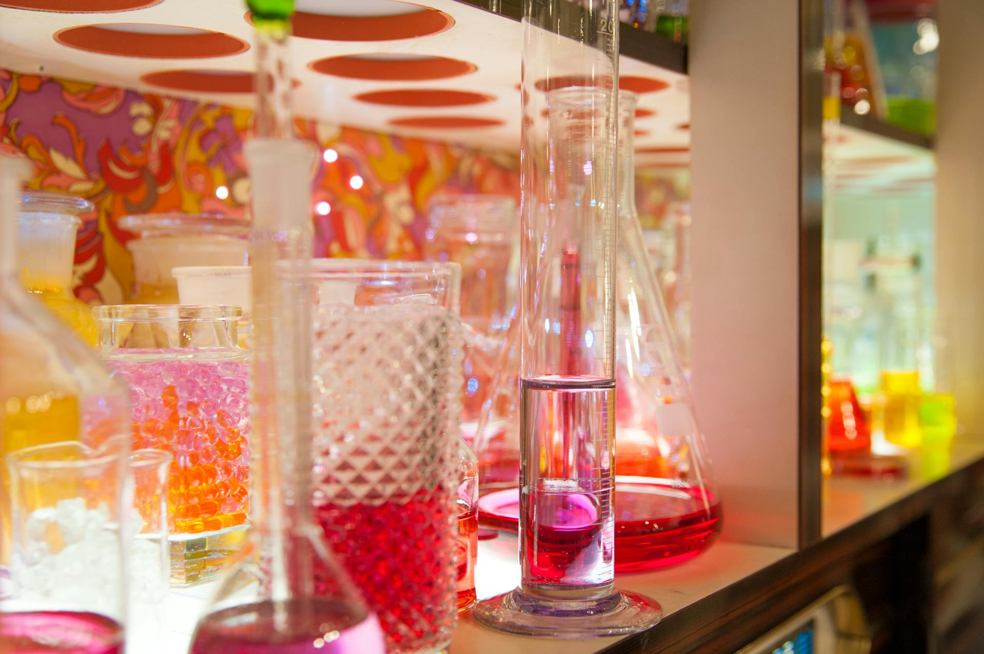 Assorted Laboratory Instruments on Shelf Filled With Liquids