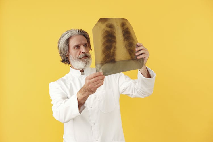 Elderly Man Holding A Radiograph