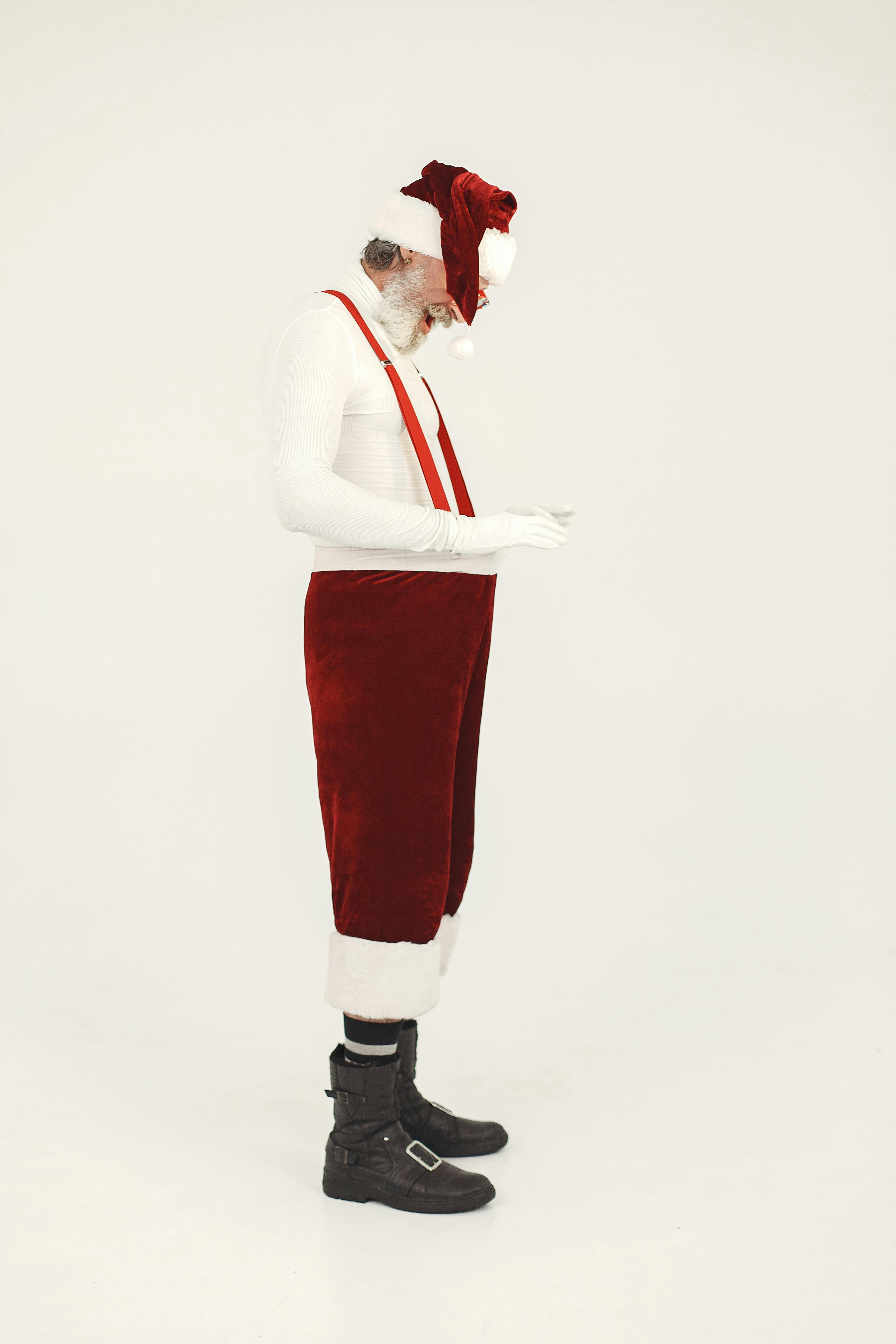 Side view of Santa Claus standing in boots with a white background, modern take.