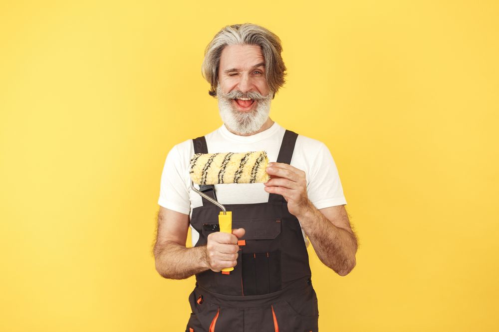 Daniel Brooks, master painter holding a paint roller