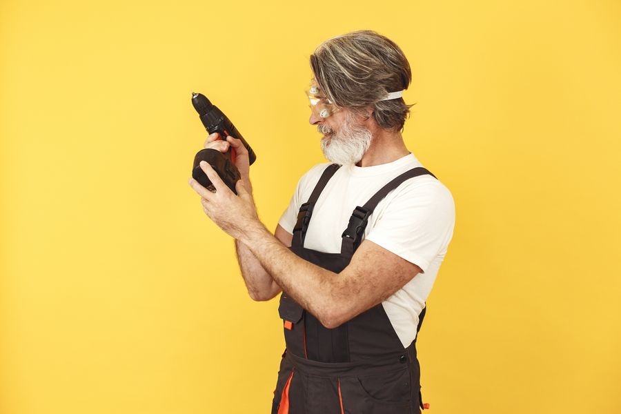 Handyman examining a cordless drill