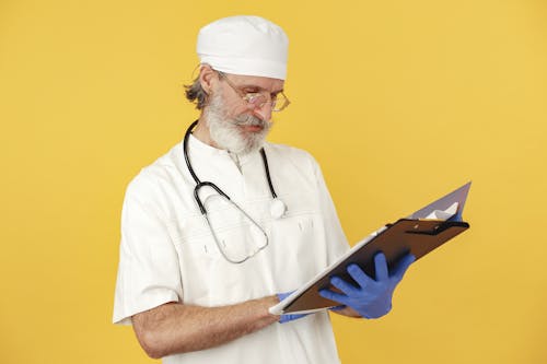 Free Man in White Chef Uniform Holding Blue Tablet Computer Stock Photo