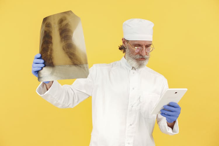 Man Holding Tablet And A Radiography