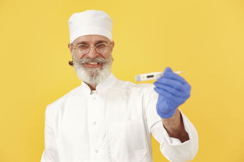 A Bearded Man Holding a Digital Thermometer