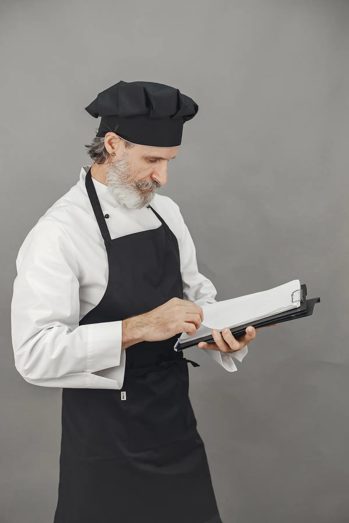 Chef uniform with a white jacket and dark apron