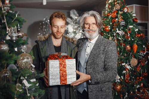 Men Holding a Christmas Present