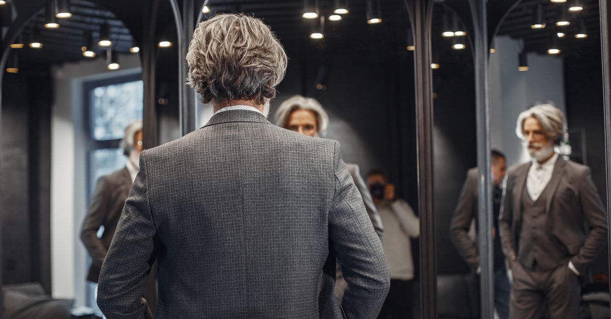 man growing beard mirror