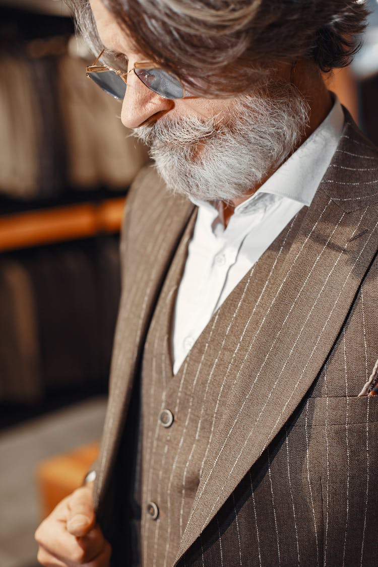 Close-Up Photo Of An Elderly Man Fitting A Black Suit