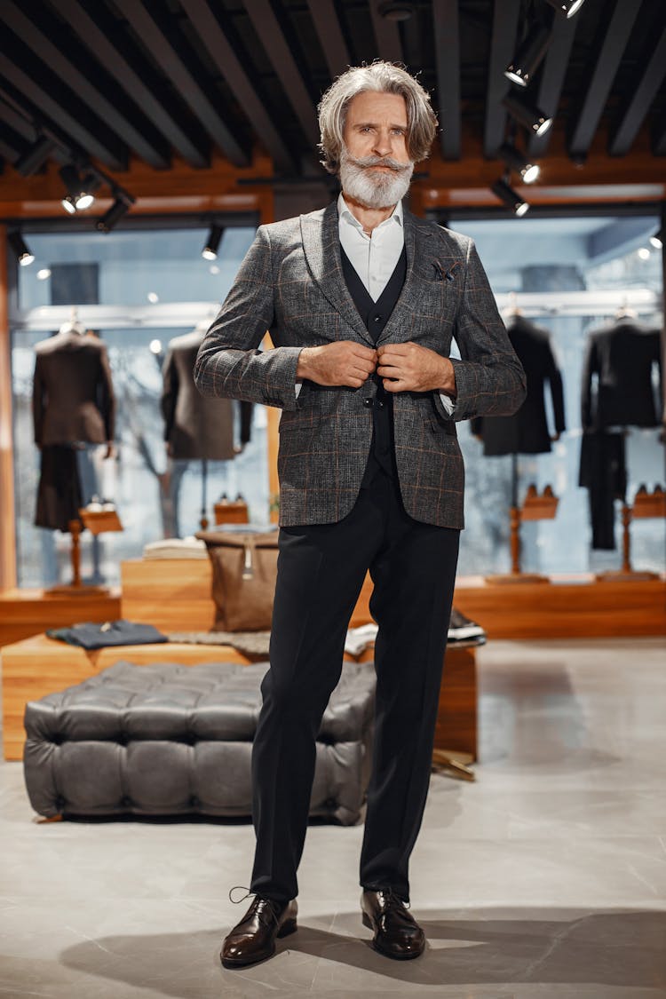 Middle Aged Man Trying On Suit In A Clothing Store 