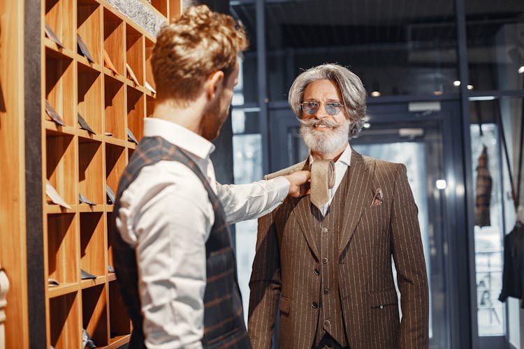 Men Choosing A Tie In A Suit Shop 