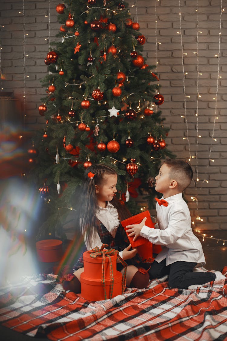 Kids Holding Their Christmas Presents 