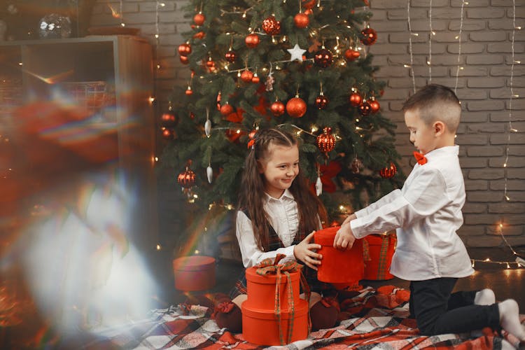 A Boy In White Long Sleeves Giving Gift To The Girl 