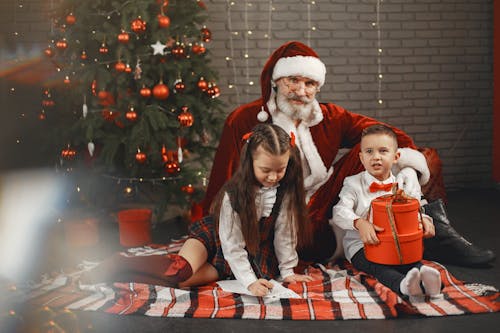 Santa Clause Pausing for a Photo with Children 