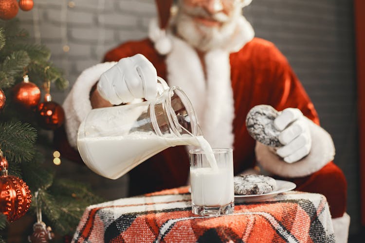 Santa Claus Pouring Milk From A Jar