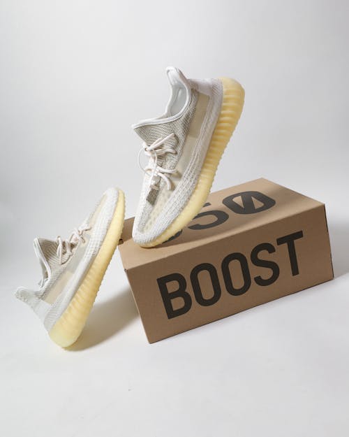 Free Pair of White Sneakers on Carton Box Stock Photo