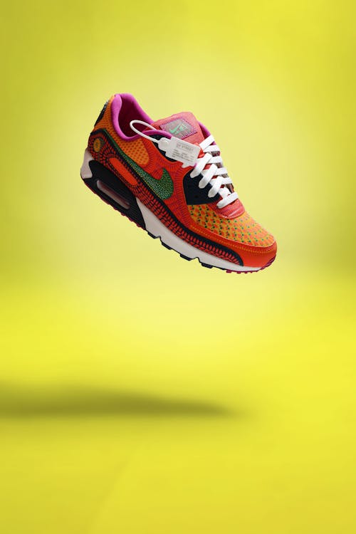 Free Colorful Nike Athletic Shoe Isolated on Yellow Background Stock Photo
