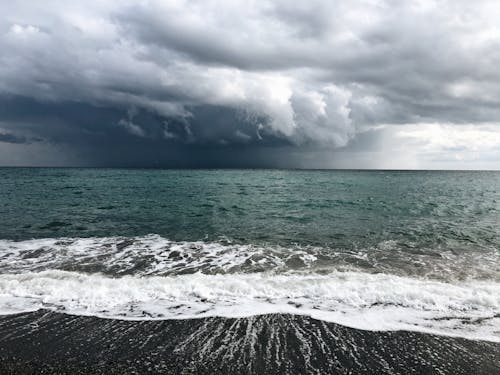 Breathtaking seascape with foamy waves and cloudy sky