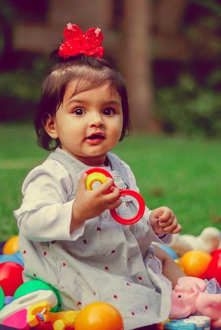 Portrait of Baby Girl Playing with Toys