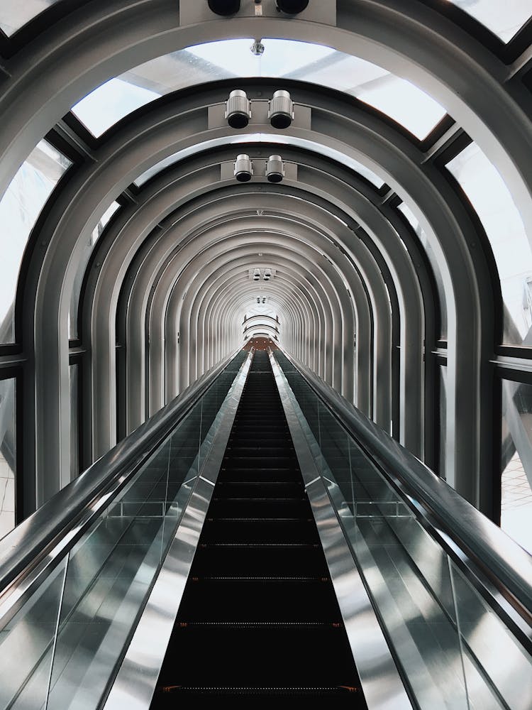 An Escalator In A Glass Tunnel