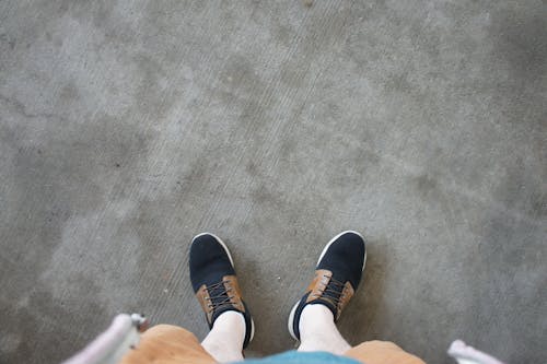 Free Person Wearing Black and White Sneakers Stock Photo
