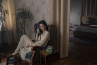Woman in Gray Shirt Sitting on Brown Wooden Armchair