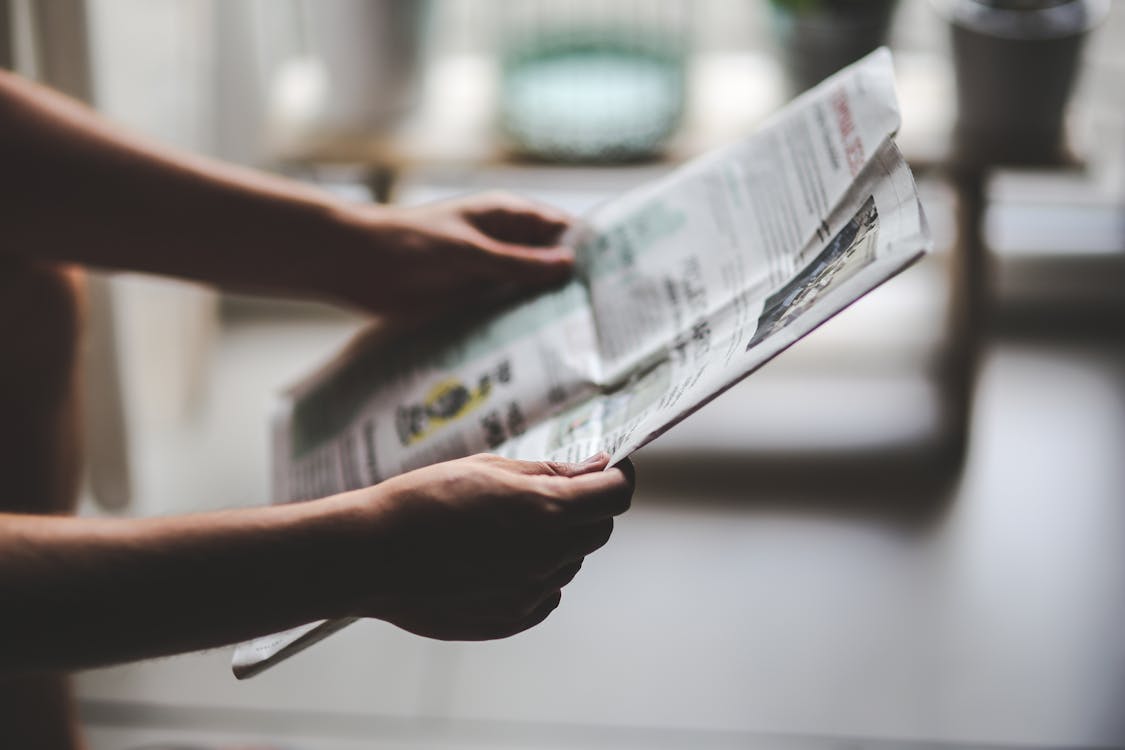 Free Person reading newspaper Stock Photo