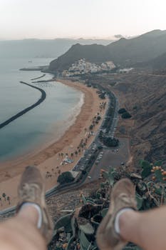 Aerial view of Playa de Las Teresitas in Tenerife, showcasing sandy beach and mountains.