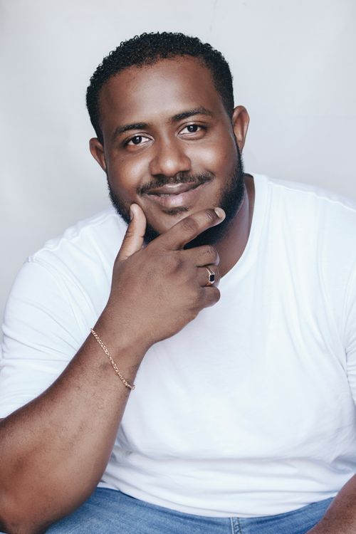 Free Studio portrait of a smiling man with facial hair, wearing casual attire indoors. Stock Photo
