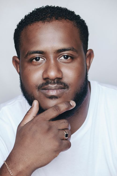 Free Close-up studio portrait of a smiling man with facial hair against a white background. Stock Photo