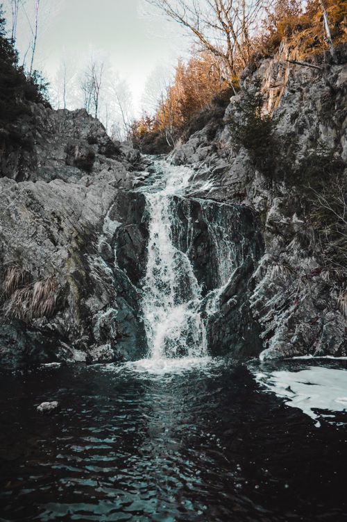 Free Picturesque waterfall cascading down rocky terrain in Malmedy, Belgium. Stock Photo