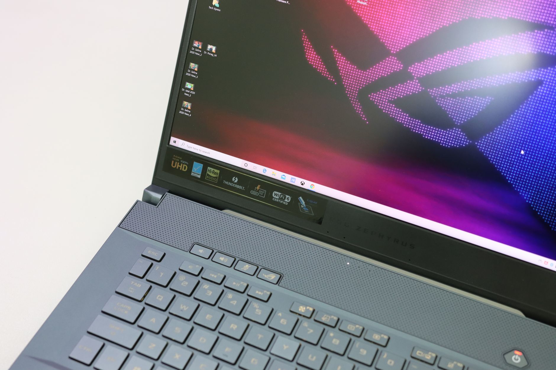 Close-up of a laptop keyboard and screen with vibrant graphics. Ideal for tech themes.