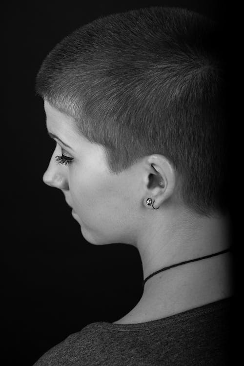 Grayscale Photo of Woman With Black Earring