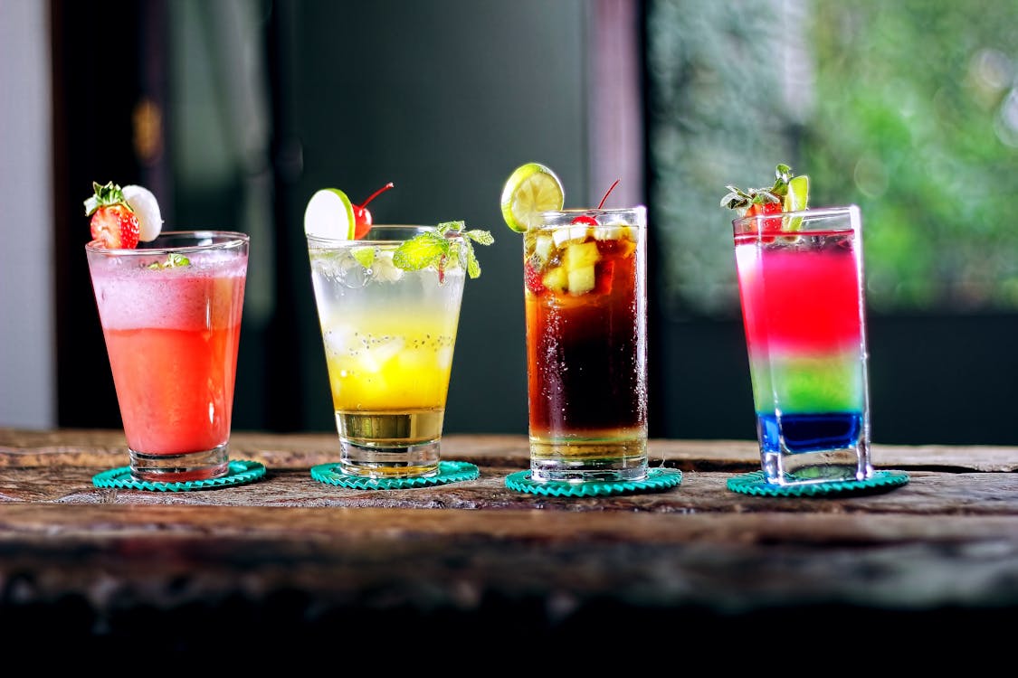 Four Cocktail Glasses on Brown Wooden Surface