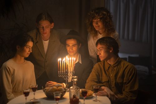 Free A serene Hanukkah gathering featuring a menorah, symbolic of Jewish traditions with friends and family. Stock Photo