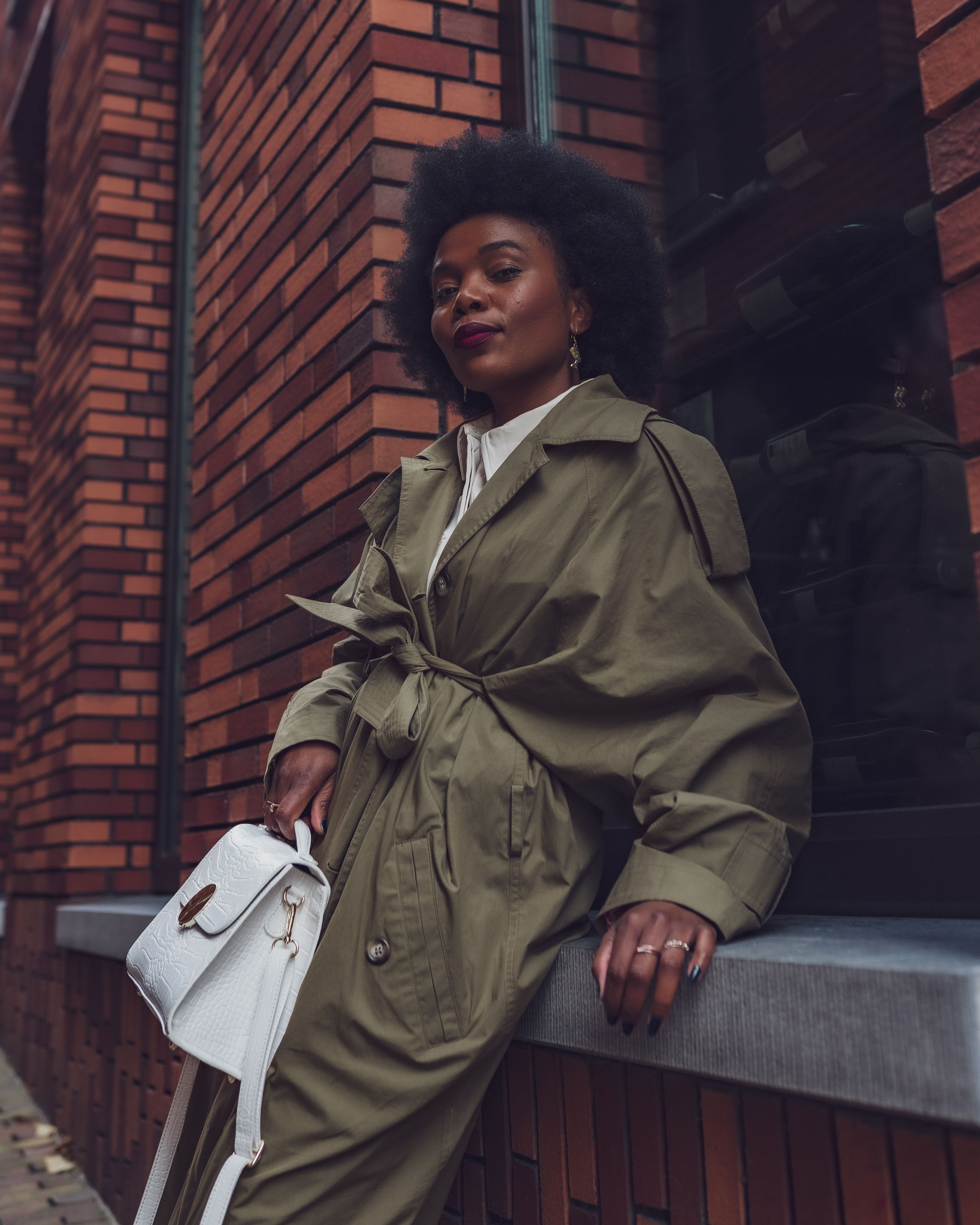 a Woman in Brown Coat Sitting · Free Stock Photo