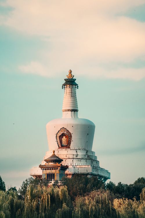 Free Captivating vertical shot of the ancient White Pagoda in Beijing's Beihai Park against a blue sky. Stock Photo